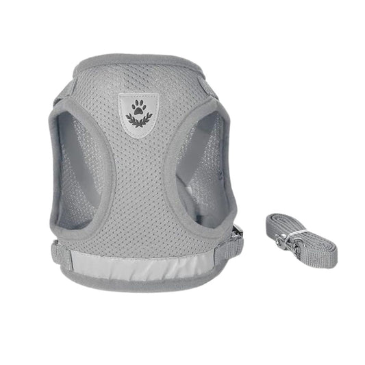 A light gray mesh dog harness with a matching adjustable strap, shown on a plain white background. The harness features a central shield-shaped patch with a dark gray paw print and leaf design.